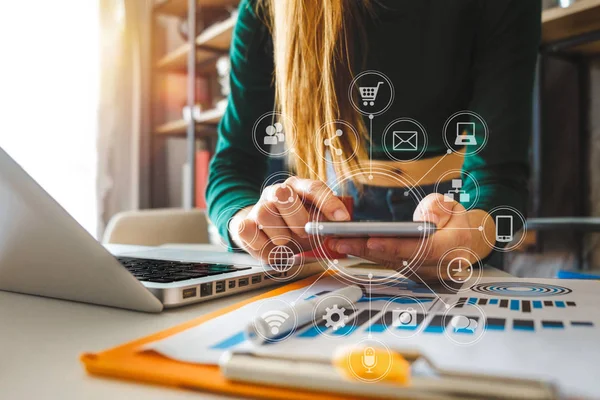 Businessman hand using laptop, tablet and smartphone  in office. Digital marketing media mobile app in virtual icon screen