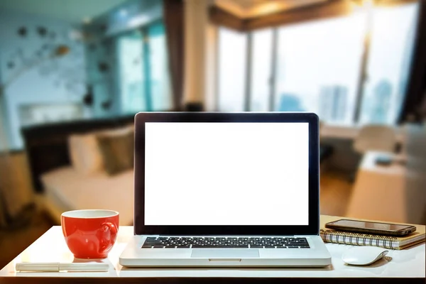 Workspace with computer laptop Monitor, Keyboard, blank screen coffee cup smartphone, and tablet on a table or White Screen Isolated in bright office room interior.