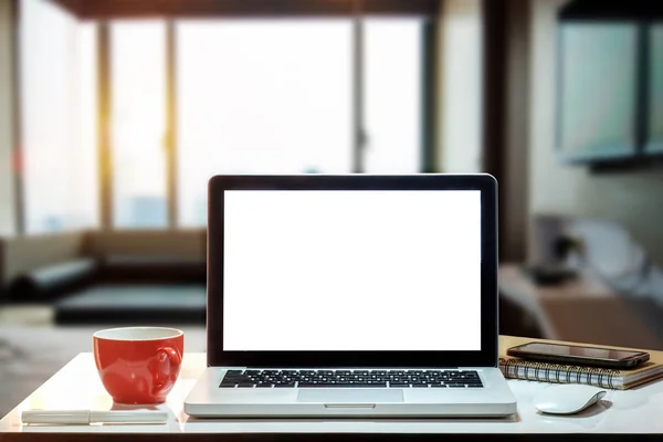 Workspace with computer Monitor, Keyboard, blank screen coffee cup smartphone, and tablet on a table or White Screen Isolated in bright office room interior.