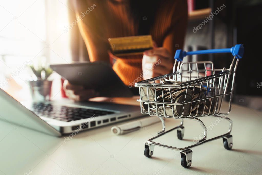 Cart Online Shopping concept. businesswoman hand using smart phone, tablet payments and holding credit card online shopping, omni channel, computer virtual icons 