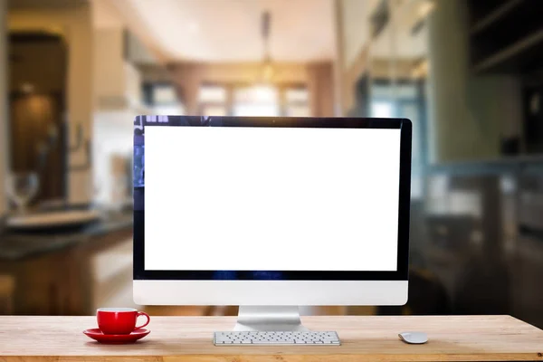 Workspace with computer Monitor, Keyboard, blank screen coffee cup smartphone, and tablet on a table or White Screen Isolated in bright office room interior.