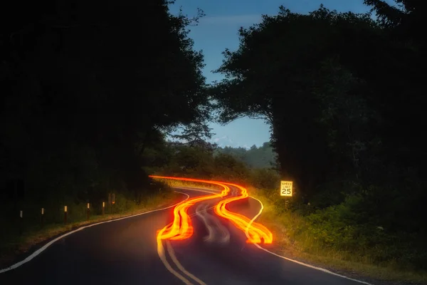Car Tail Light Trails Winding Road Night Forest — Stock Photo, Image