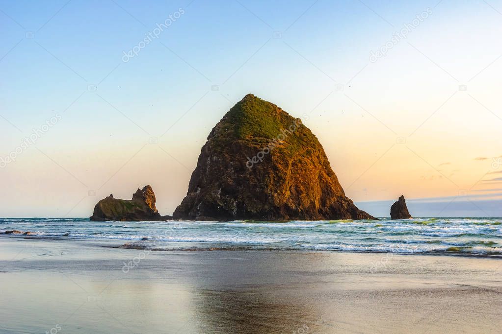 Beautiful Haystack Rock, famous natural landmark of the Pacific Coast, at sunset, Cannon Beach, Oregon Coast, USA.