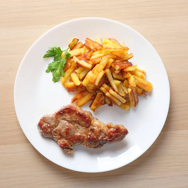 Pork Steak Sliced Fried Potatoes White Dish Wooden Table Top — Stock Photo, Image