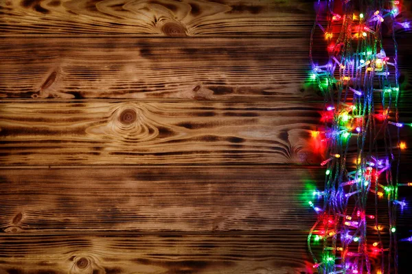 Luci di Natale su sfondo di legno — Foto Stock