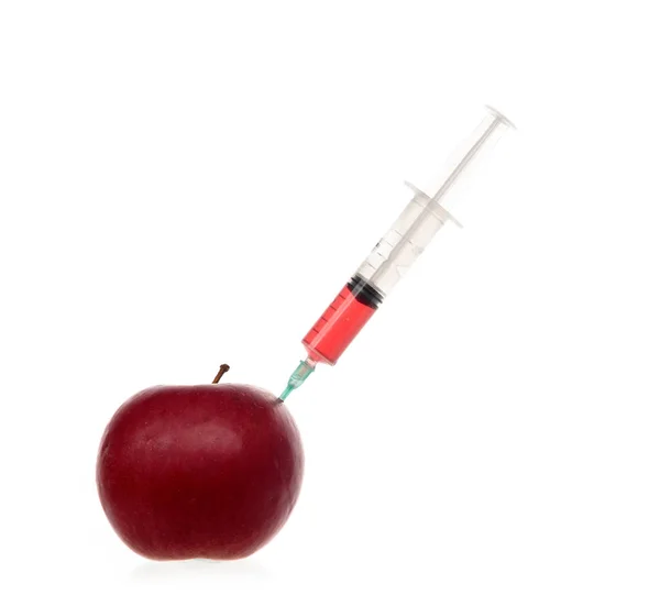 Syringe with colored liquid stuck into an apple isolated on white. — Stock Photo, Image