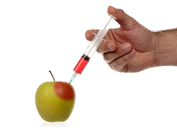 Male hand makes an injection syringe into an apple isolated on white. — Stock Photo, Image