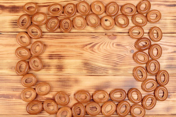 Montón de rosquillas esparcidas en la mesa de madera con espacio de copia —  Fotos de Stock