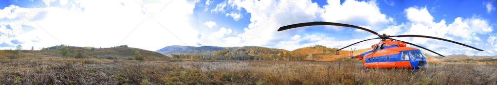 Helicopter on the background of the autumn landscape. Panorama.