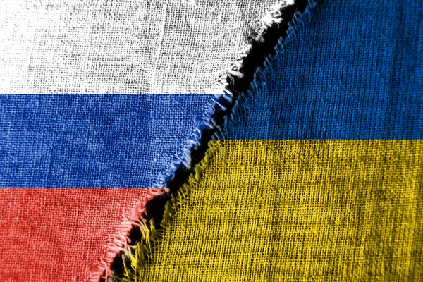 The gap between the two flags, Russia and Ukraine, as a concept of political confrontation.