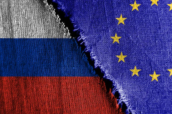 The gap between the two flags, Russia and European Union, as a concept of political confrontation.