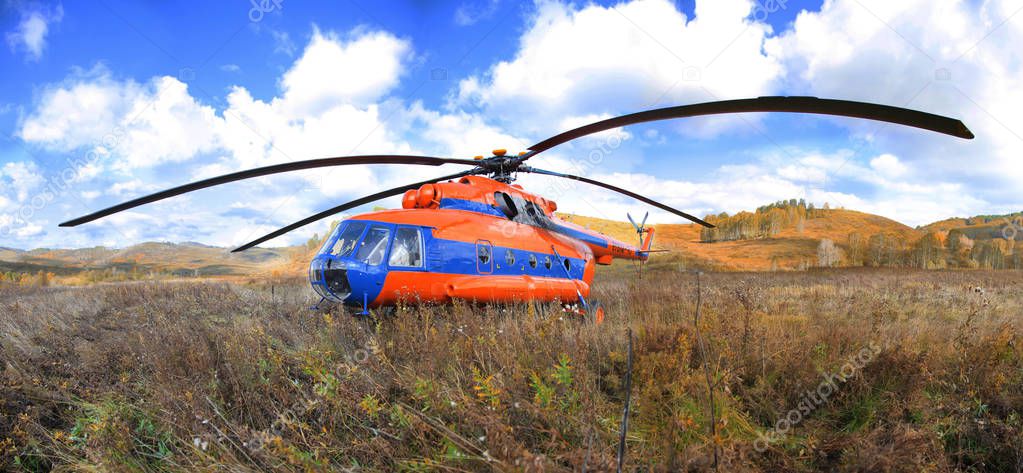 Helicopter on the background of the autumn landscape