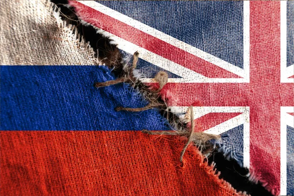 The gap between the two flags, Russia and Great Britain, as a concept of political confrontation.
