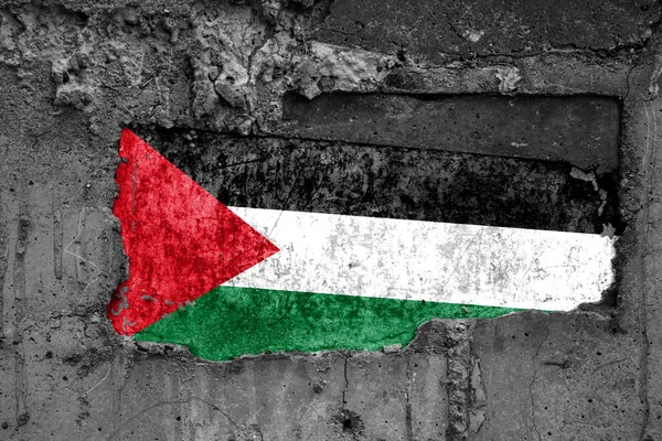 The flag of Palestine on a dirty wooden surface, built into a concrete base, with scuffs and scratches. Loss or destruction conception. — Stock Photo, Image