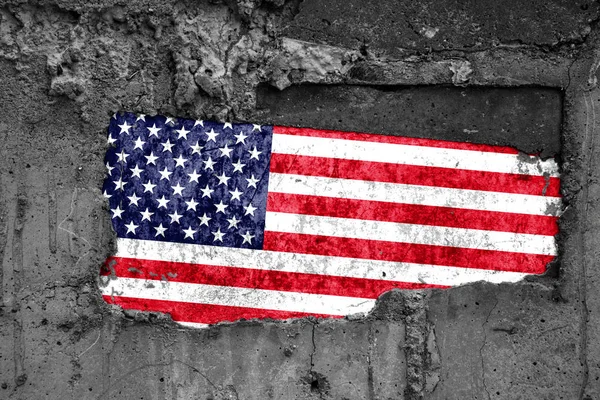 The flag of United States of America on a dirty wooden surface, built into a concrete base, with scuffs and scratches. Loss or destruction conception. — Stock Photo, Image