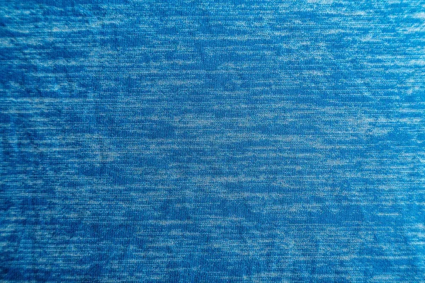 Uma textura de tecido azul uniformemente iluminada com sombras suaves . — Fotografia de Stock