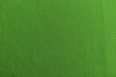 Yumuşak gölgelerle homojen aydınlatılmış yeşil kumaş dokusu.