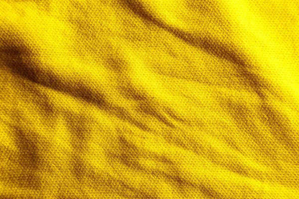 Uma textura de tecido amarelo uniformemente iluminado com sombras suaves . — Fotografia de Stock