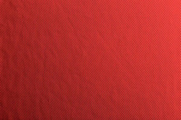 Une texture de tissu rouge uniformément éclairée avec des ombres douces . — Photo