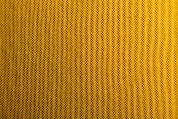 Une texture de tissu jaune uniformément éclairée avec des ombres douces . — Photo
