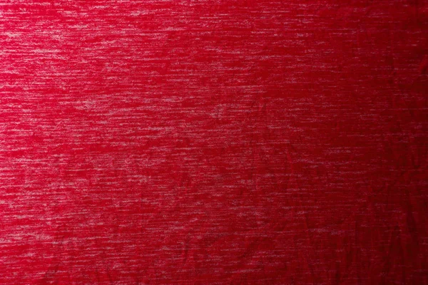Une texture de tissu rouge uniformément éclairée avec des ombres douces . — Photo