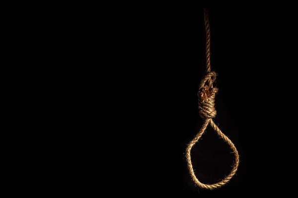 Loop of braided rope on a gloomy dark background, failure or suicide concept — Stock Photo, Image