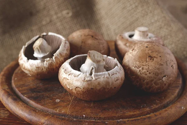 Fresh brown mushrooms on wooden table ストック画像