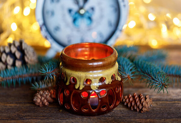 Ceramic candle holder on a wooden background, Christmas entourage