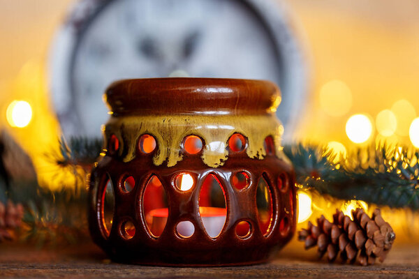 Ceramic candle holder on a wooden background, Christmas entourage