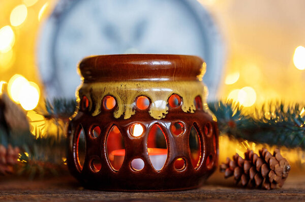 Ceramic candle holder on a wooden background, Christmas entourage