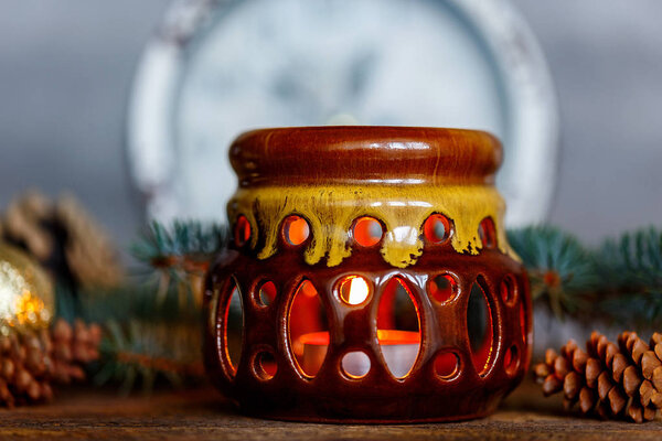 Ceramic candle holder on a wooden background, Christmas entourage