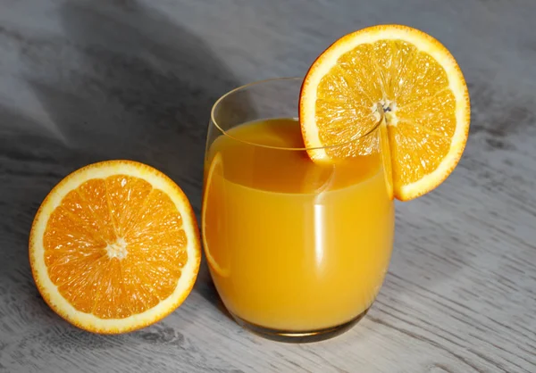 Ahşap arka plan üzerinde bir bardak portakal suyu — Stok fotoğraf