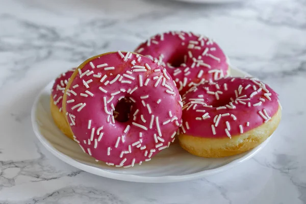 Donaltsa donuts with pink icing — Stock Photo, Image