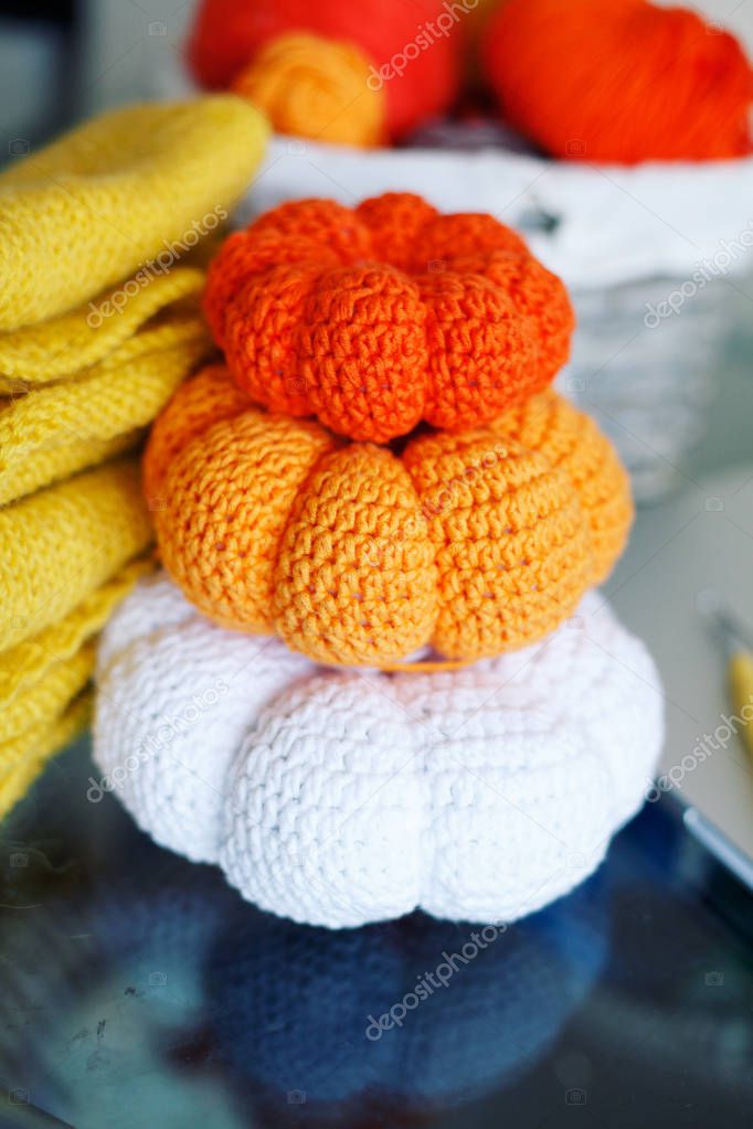 Group of colorful pumpkins knitted from yarn