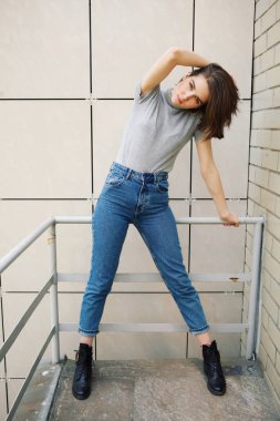 binanın yakınındaki korkulukta poz veren çekici kadın