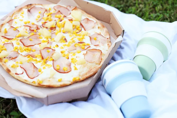 Pizza Hawaiian with pineapple and chicken, outdoor picnic, food to go, lunch in your garden