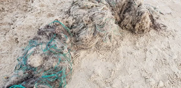 Old fisherman net laying on the sand in beach