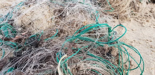 Old fisherman net laying on the sand in beach