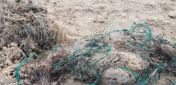 Old fisherman net laying on the sand in beach