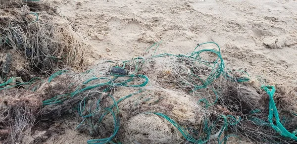 Old fisherman net laying on the sand in beach