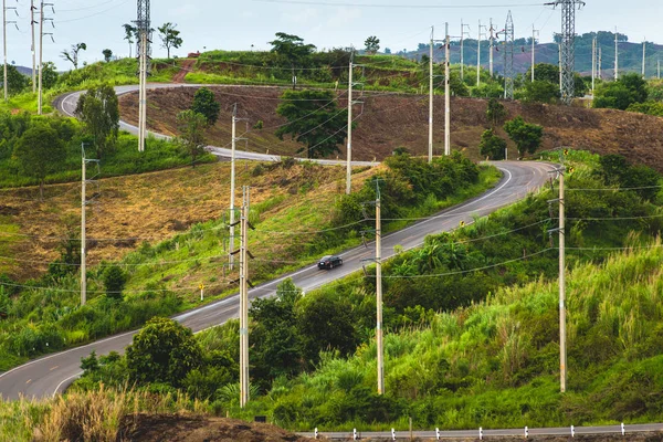 Road to the Curve on Hill with Electric Poles