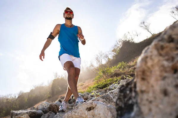 Pandangan Bawah Olahragawan Berjalan Atas Batu Gunung Dengan Sinar Matahari — Stok Foto