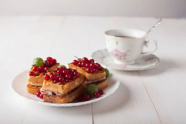 维也纳人的华夫饼与葡萄干和一杯茶站在桌上 — 图库照片