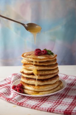 beyaz bir tablo üzerinde beyaz bir tabakta ahududu ile Pancakes