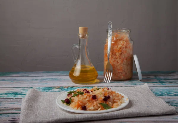 fermented cabbage salad with cranberries, a bottle of vegetable