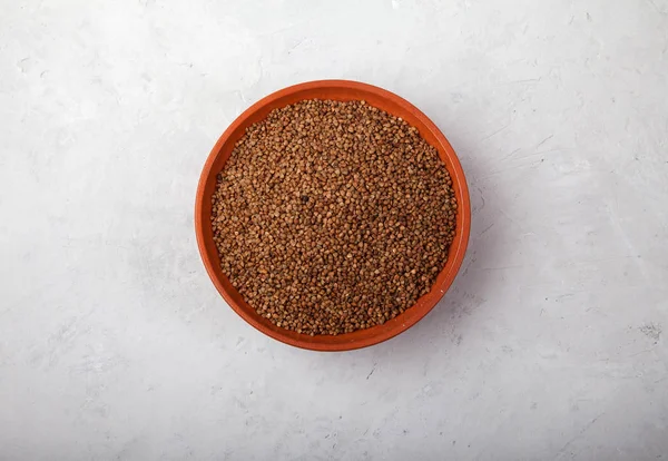 Buckwheat in a clay bowl on a white background. superfood — Stock Photo, Image