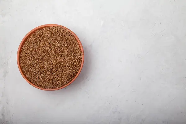 Buckwheat in a clay bowl on a white background. superfood — Stock Photo, Image
