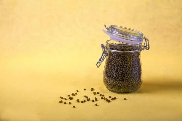 Mung bean in a jar on a yellow background. Copy spaes. Horizontally — Stock Photo, Image