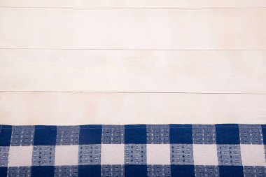 Mavi hücreleri ile keten peçete beyaz ahşap arka plan üzerinde düz yatıyor. Yatay