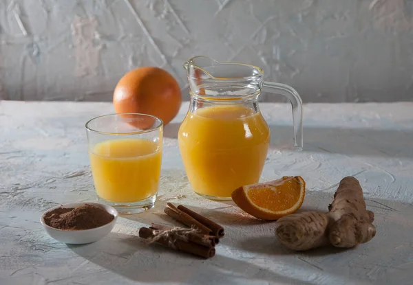 Orange Juice Ginger Glass Jug Glass Cinnamon Sticks Light Background — Stock Photo, Image